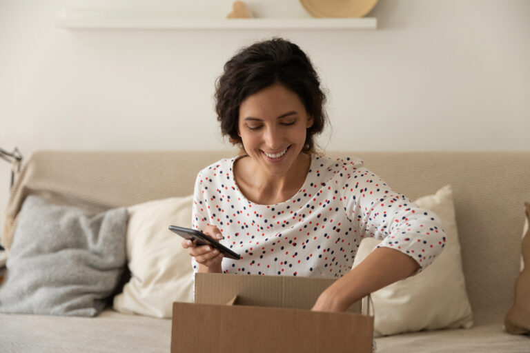 Smiling,Young,Caucasian,Woman,Sit,On,Couch,At,Home,Unpack